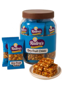 rudras dryfruit chikki jar with two nsmall and bowl of chikki pieces front view